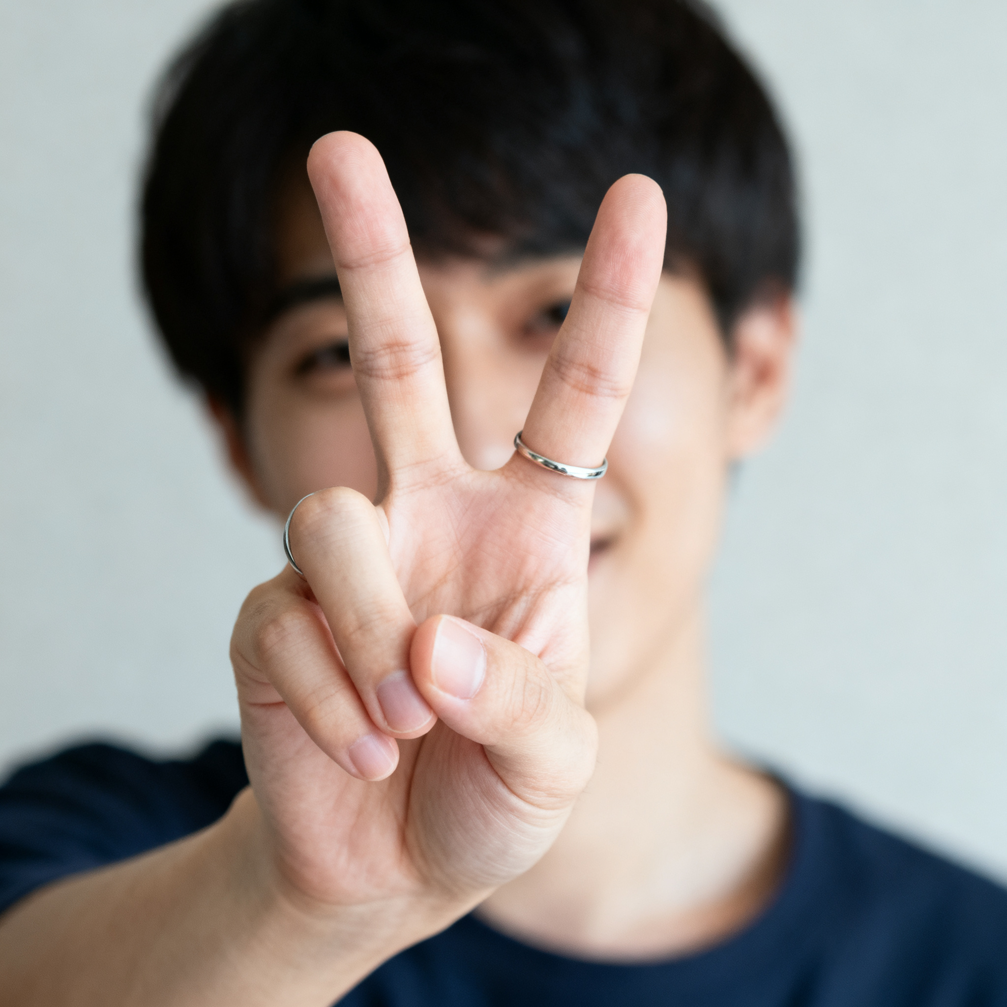 A person making a peace sign with their right hand, clearly 