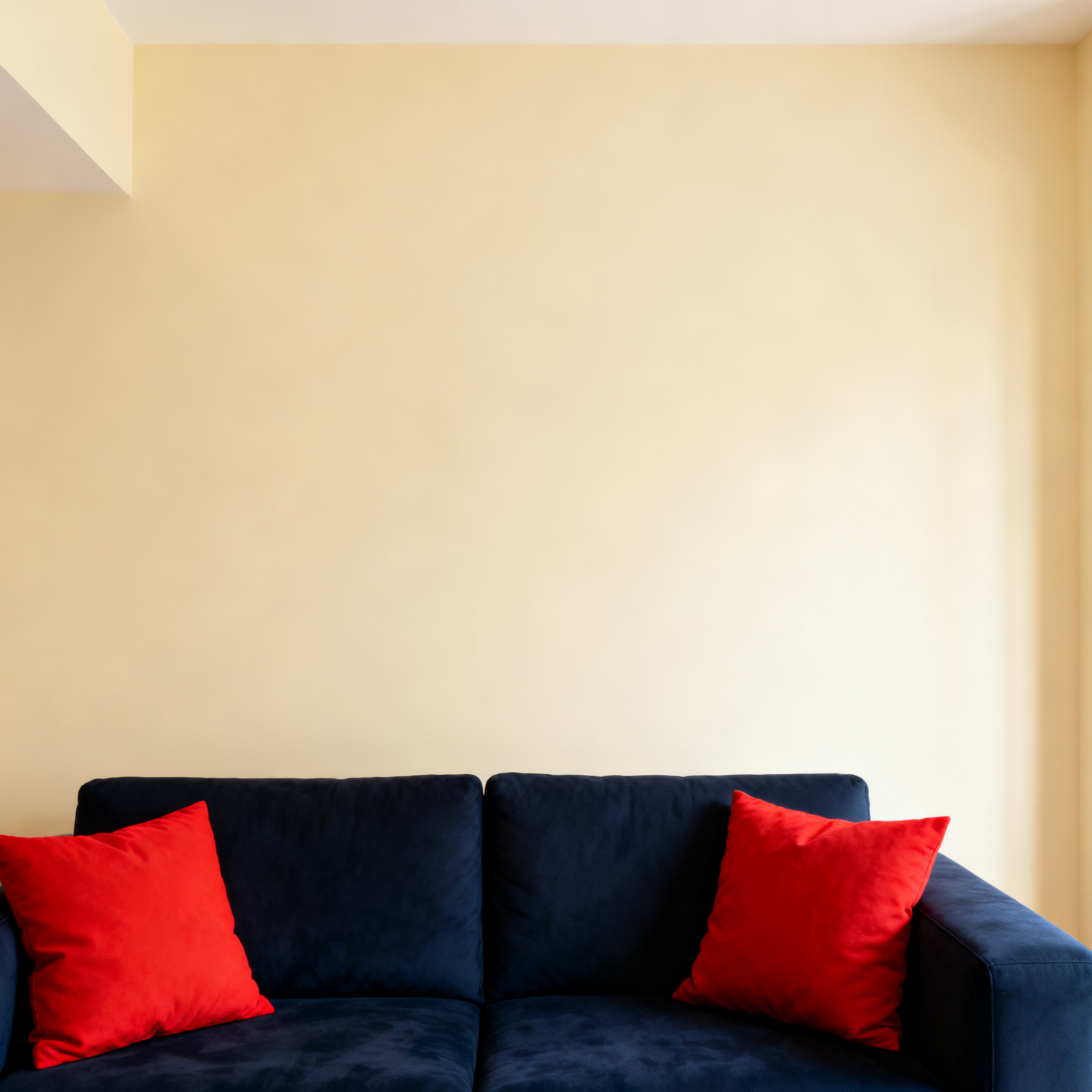 A minimalist room with walls in #F5E6CC (warm cream), a sofa