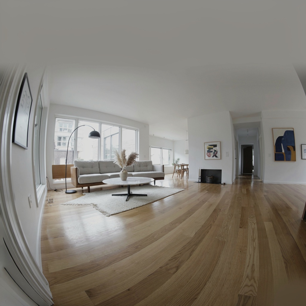 A wide-angle shot of a modern living room interior showing e