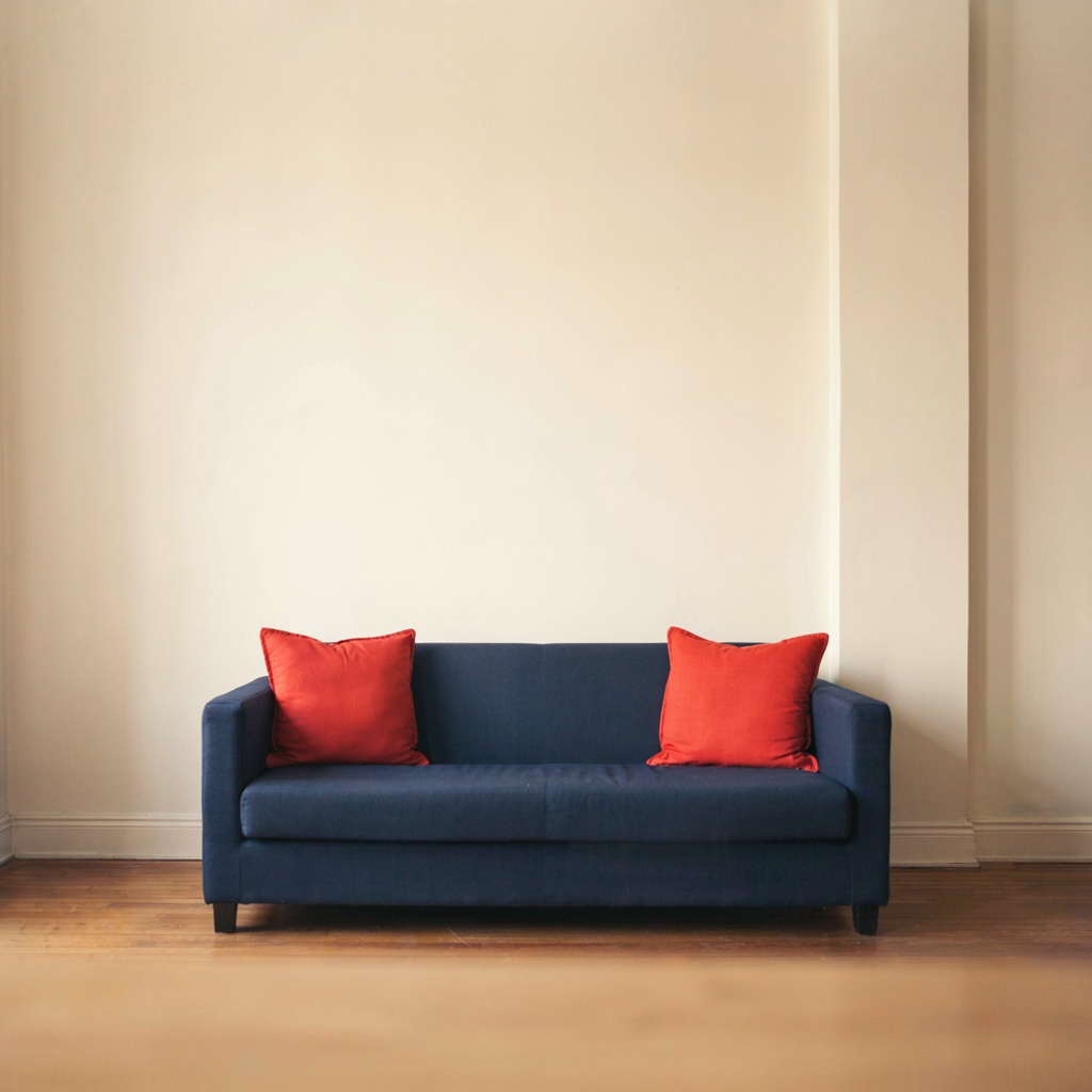 A minimalist room with walls in #F5E6CC (warm cream), a sofa
