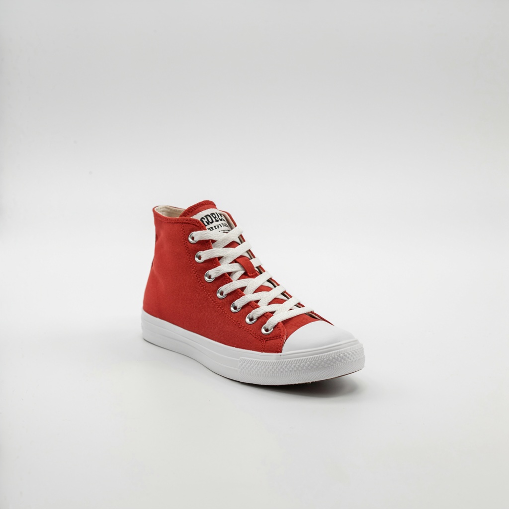 A single red sneaker on a clean white background with soft s