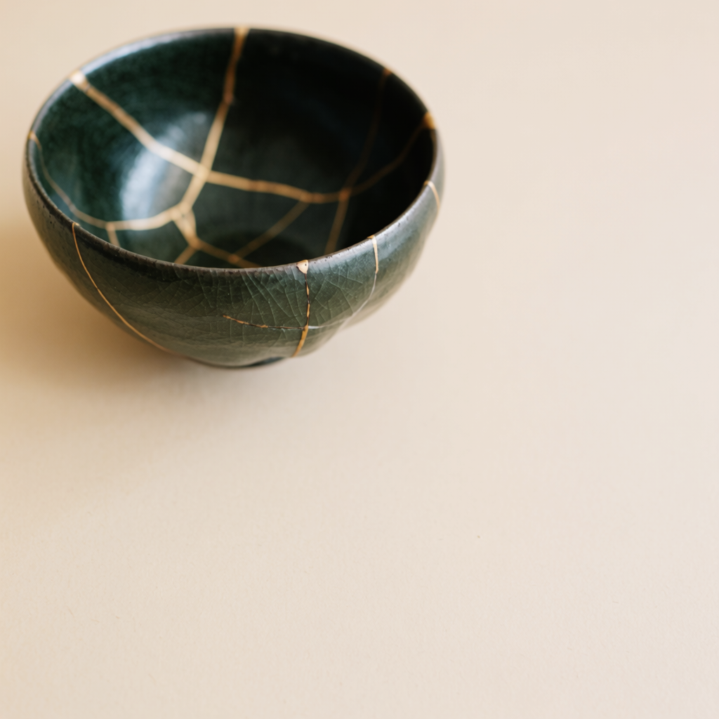 A Japanese kintsugi bowl — cracked ceramic repaired with vis