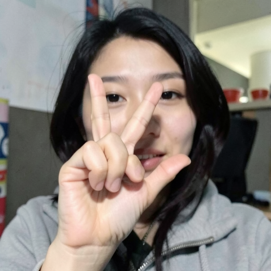 A person making a peace sign with their right hand, clearly 