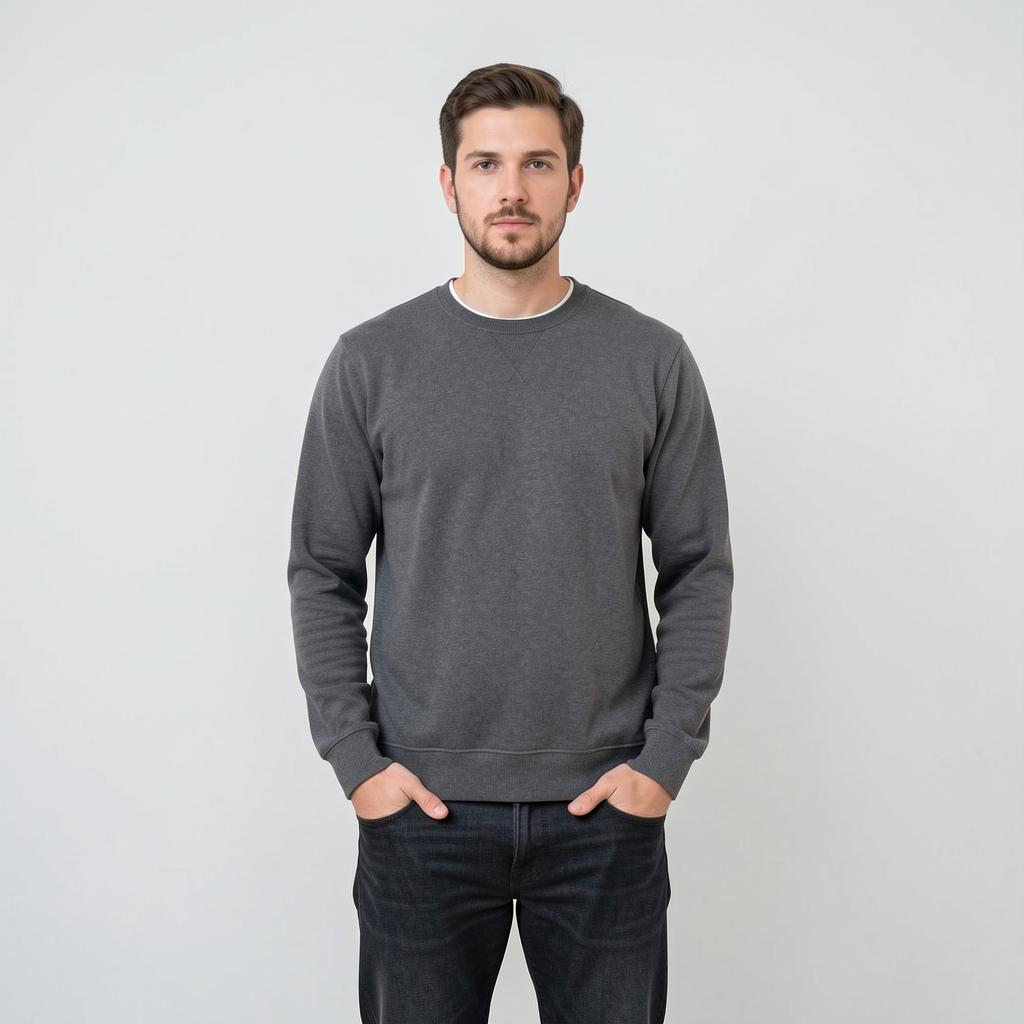 A man standing straight facing the camera, hands in pockets,