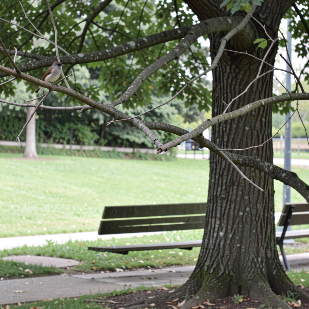 A bird perched on a branch, the branch extending from a tree