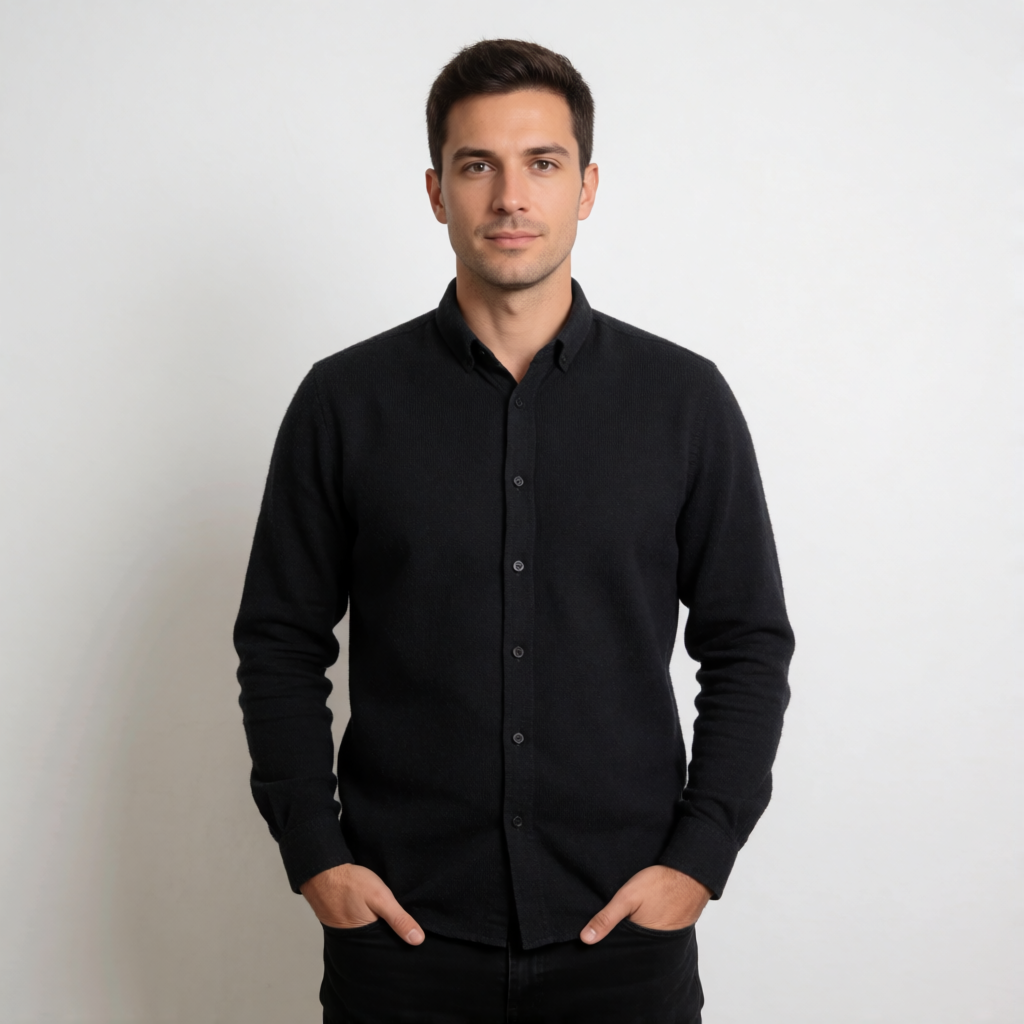 A man standing straight facing the camera, hands in pockets,
