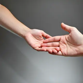 Two people doing a high-five, palms meeting with all fingers
