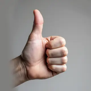 A hand giving a thumbs-up with four fingers curled and thumb