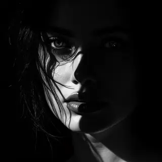 A portrait with dramatic split lighting — half the face brig