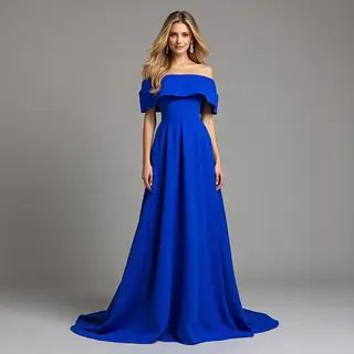 A woman wearing a royal blue evening dress against a neutral