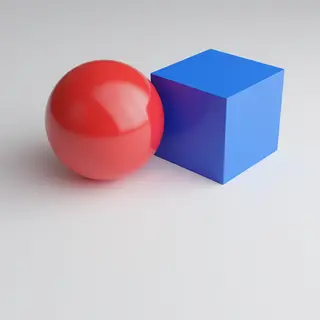 A red ball and a blue cube sitting side by side on a white s