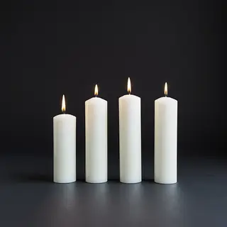 Exactly 4 white candles standing on a dark surface