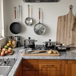 A kitchen with pots, pans, a stove, and a cutting board but 