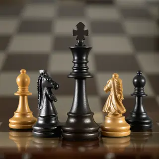 Five chess pieces on a board: a king in the center, a queen 