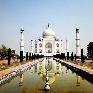 The Taj Mahal in Agra seen from the reflecting pool, with ac