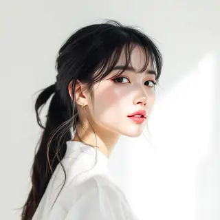 A high-key portrait of a person against a bright white backg