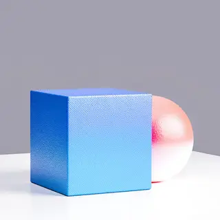 A red ball and a blue cube sitting side by side on a white s