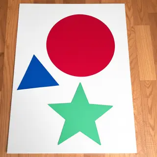 A large red circle, a small blue triangle, and a medium gree