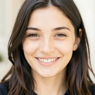 A close-up portrait of a young woman with a warm natural smi