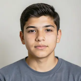 A headshot of a teenager with a relaxed, neutral face