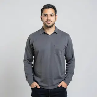A man standing straight facing the camera, hands in pockets,