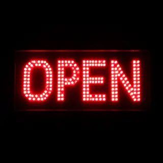 The word 'OPEN' displayed on a red LED sign with glowing pix