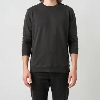 A person standing with both hands visible at their sides, fi