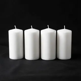 Exactly 4 white candles standing on a dark surface