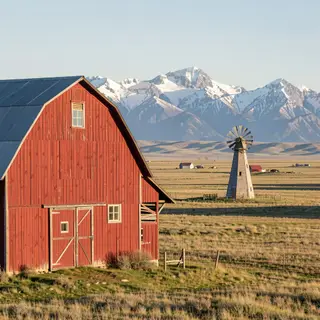 A landscape with a red barn in the foreground at large scale