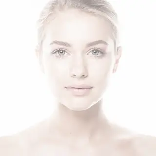 A high-key portrait of a person against a bright white backg