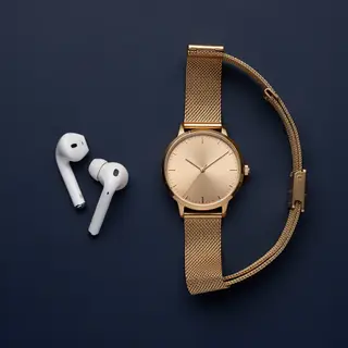 A product flat-lay on a #1A1A2E (deep dark blue) background,