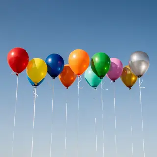Exactly 11 colorful balloons floating against a clear blue s