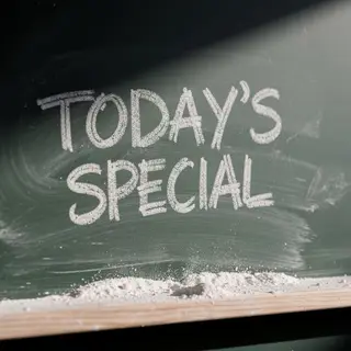 The phrase 'TODAY'S SPECIAL' written in white chalk on a dar