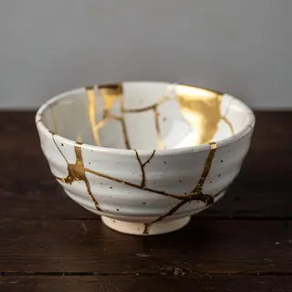 A Japanese kintsugi bowl — cracked ceramic repaired with vis