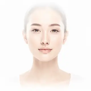 A high-key portrait of a person against a bright white backg