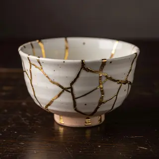 A Japanese kintsugi bowl — cracked ceramic repaired with vis