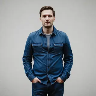 A man standing straight facing the camera, hands in pockets,