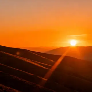A landscape photograph bathed in golden hour light — long wa
