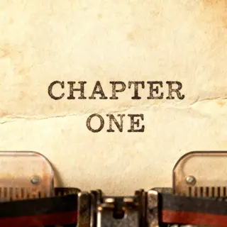 The word 'CHAPTER ONE' typed on aged paper with a vintage ty