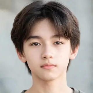 A headshot of a teenager with a relaxed, neutral face