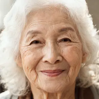 An elderly woman in her 80s with deep wrinkles and white hai