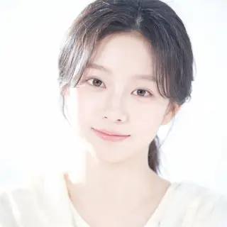 A high-key portrait of a person against a bright white backg