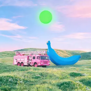 A pink fire truck, a blue banana, and a green sun in a surre