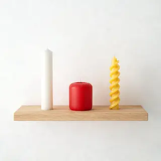 A tall thin white candle, a short fat red candle, and a medi