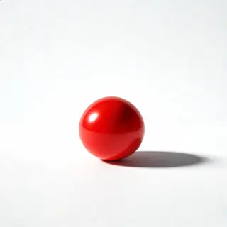 A red sphere on a white surface with a single shadow cast to
