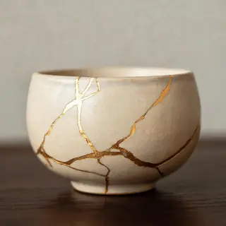 A Japanese kintsugi bowl — cracked ceramic repaired with vis