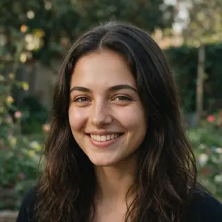 A close-up portrait of a young woman with a warm natural smi