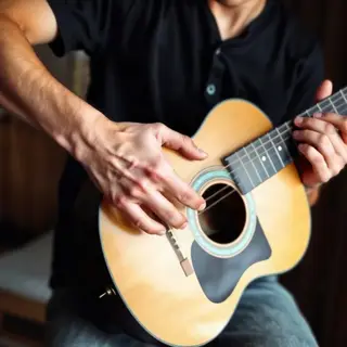 A person playing an acoustic guitar with left hand on the fr