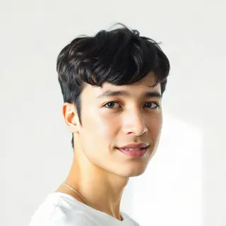 A high-key portrait of a person against a bright white backg