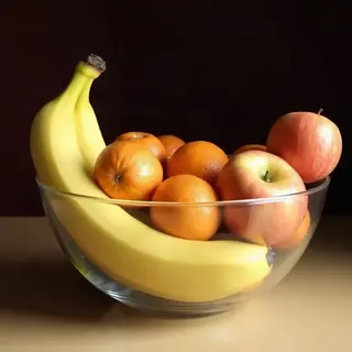 A fruit bowl containing exactly 3 bananas, 4 oranges, and 2 